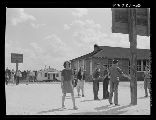 Untitled photo, possibly related to: The white schoolhouse in the background was erected by Hazlehurst Farms Inc. to accommodate the increased enrollment as a result of families moving into prefabricated houses