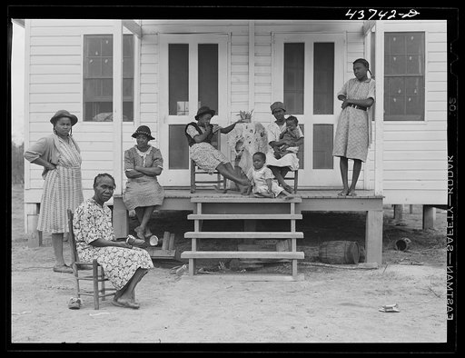 Negro family and friends at one of the prefabricated houses for Negroes at Hazlehurst Farms Inc., Hazlehurst, Georgia