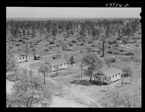 Untitled photo, possibly related to: Prefabricated houses at Hazlehurst Farms Inc., showing both cleared and uncleared land. Hazlehurst, Georgia