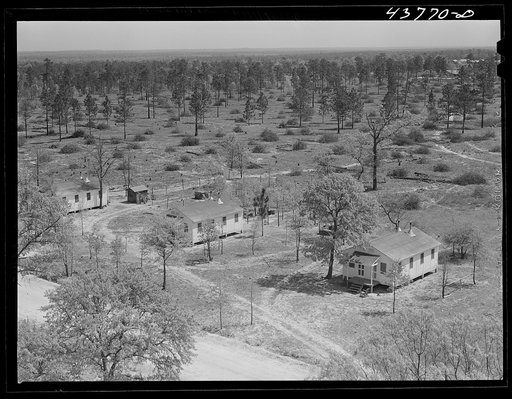 Untitled photo, possibly related to: Prefabricated houses at Hazlehurst Farms Inc., showing both cleared and uncleared land. Hazlehurst, Georgia