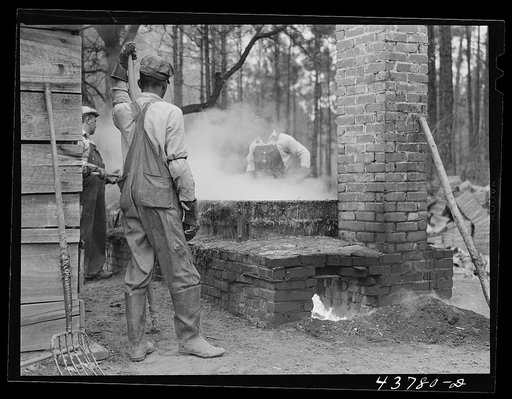 Cleaning turpentine cups in boiling water at a still near Pembroke, Georgia