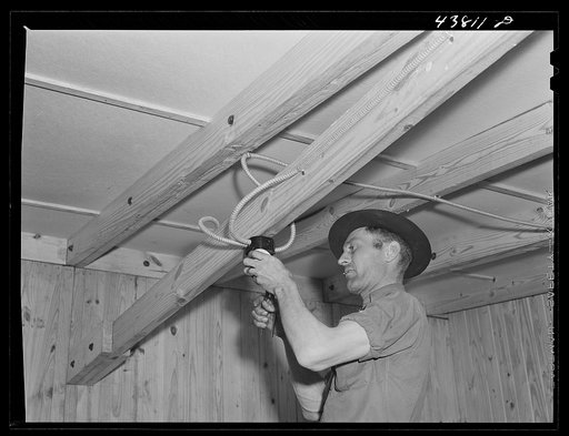 Installing electric wiring in a prefabricated house at the FSA (Farm Security Administration) project in Pacolet, South Carolina