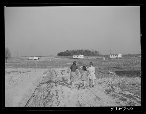 While water pipes are being laid families had to get their water at one of the wells nearby. When water system is completed there will be a pump at every house. Pacolet, South Carolina. At the FSA (Farm Security Administration) prefabricated houses