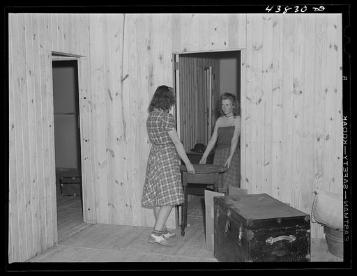 Arranging furniture at the new prefabricated house of the Lee family. Near Pacolet, South Carolina