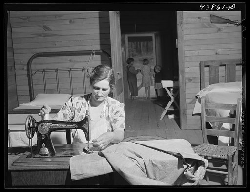 Mrs. L. Smith sews many of the shirts her husband wears when working on the farm. Carroll County, Georgia (see general caption)