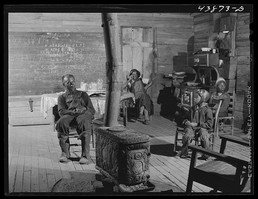 Untitled photo, possibly related to: Negro preacher and his wife live in this converted schoolhouse with two grandchildren. The rest of their children have all left the county. Heard County, Georgia