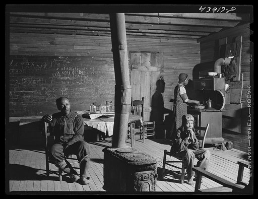 Negro preacher and his wife live in this converted schoolhouse with two grandchildren. The rest of their children have all left the county. Heard County, Georgia