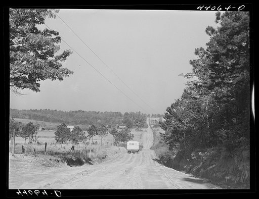 Three of the Smith family children go off to school in school bus which calls at their home. Carroll County, Georgia