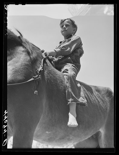 Untitled photo, possibly related to: Colie Smith gets a ride on one of two horses owned by the Smith family. Carroll County, Georgia