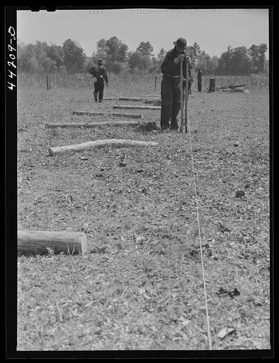 Untitled photo, possibly related to: CCC (Civilian Conservation Corps) boys putting up a fence. Greene County, Georgia