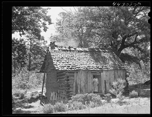 Midwife in doorway of her house. Near Siloam, Greene County, Georgia