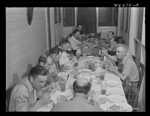 Workers from the powder plant having dinner at their boarding house. Childersburg, Alabama
