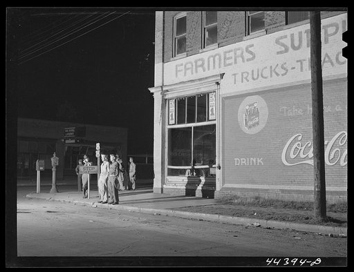 Soldiers from a nearby Army camp waiting for a bus in Anniston, Alabama