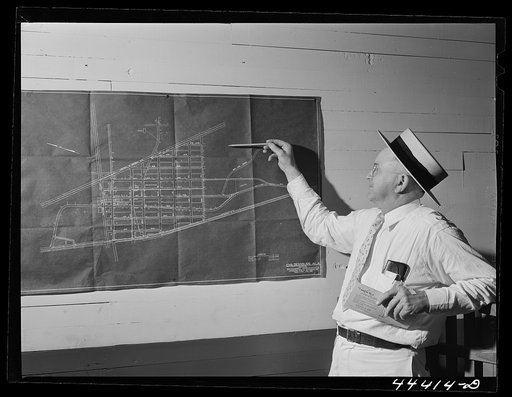 Mr. H.D. Wilson, mayor of Childersburg, Alabama pointing, out the location of one of the expected federal housing development