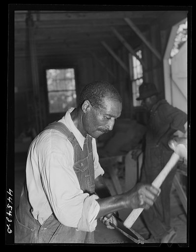 Untitled photo, possibly related to: Negro farmer sharpening plow points at a new vocational school in Greene County, Georgia