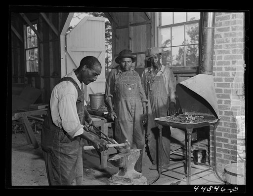 Untitled photo, possibly related to: Negro farmer sharpening plow points at a new vocational school in Greene County, Georgia