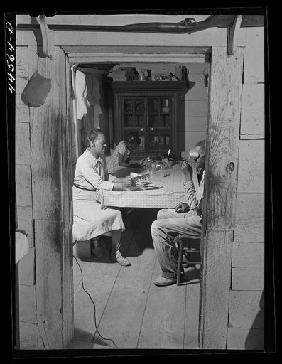 Untitled photo, possibly related to: Ward and his wife looking at sterioptican pictures. FSA (Farm Security Administration) borrower in Greene County, Georgia