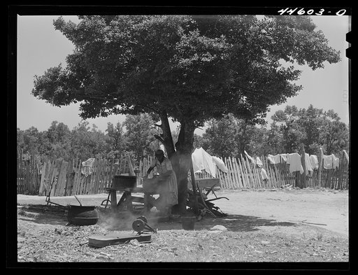 Negro tenant farmer's wife washing clothes in the backyard. Greene County, Georgia