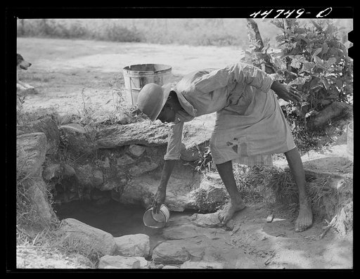 Getting water out of a spring on a farm in northern Greene County, Georgia