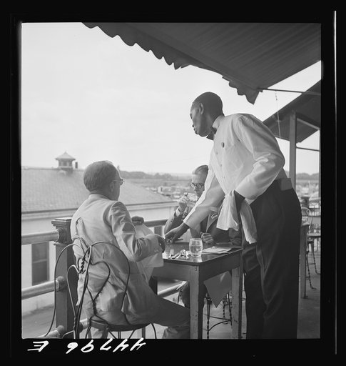 Negro waiter in Hertzog's, seafood restaurant along the waterfront. Washington, D.C.