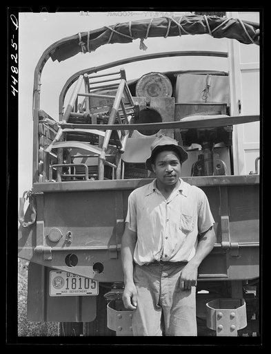 Untitled photo, possibly related to: CCC (Civilian Conservation Corps) trucks are helping this young man's family move their belongings out of the area being taken over by the Army. Caroline County, Virginia
