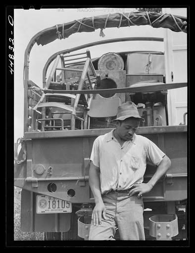 CCC (Civilian Conservation Corps) trucks are helping this young man's family move their belongings out of the area being taken over by the Army. Caroline County, Virginia