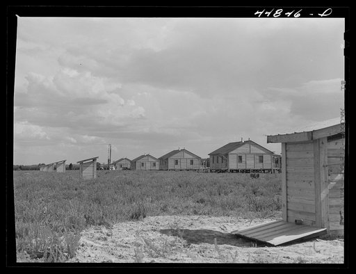 Group of prefabricated houses and privies that have been built by the FSA (Farm Security Administration) to take care of some of the white farmers who had to move out of the area taken over by the Army for maneuver grounds. Milford, Caroline County, Virginia