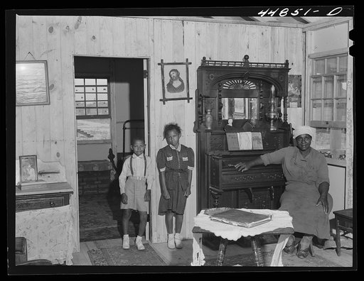 This family had to move out of the area being taken over by the Army for maneuver grounds. They now live in one of the prefabricated houses that were built by FSA (Farm Security Administration). Milford, Caroline County, Virginia