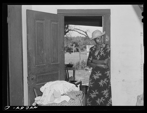 This woman is all packed and waiting for the truck to take her belongings out of the area being taken over by the Army. Caroline County, Virginia
