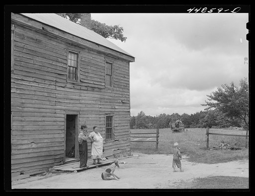 Mr. and Mrs. Russell Tombs watching the last load of their belongings go off. They are moving out of the area being taken over by the Army for maneuver grounds. Caroline County, Virginia