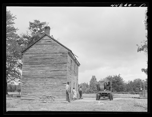 Mr. and Mrs. Russell Tombs watching the last load of their belongings go off. They are moving out of the area being taken over by the Army for maneuver grounds. Caroline County, Virginia