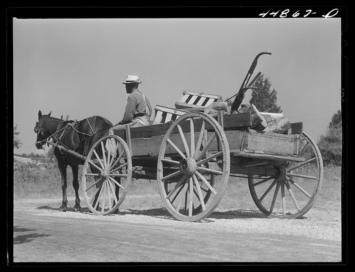 Negro farmer carting some of his farm equipment out of the area that is being taken over by the Army. Caroline County, Virginia
