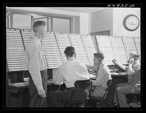In the airport control room with which incoming and outgoing airliners are in constant communication. Flight data is kept on the white slips of cardboard. A new electrical control board just completed on the opposite side of the room will replace this one Washington, D.C. municipal airport