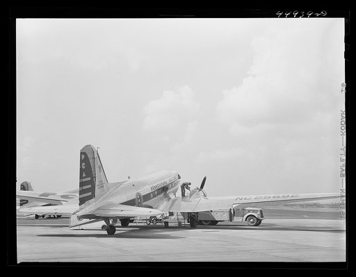Untitled photo, possibly related to: Oil for the engine of an airliner preparatory to takeoff. Municipal airport, Washington, D.C.