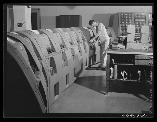 Untitled photo, possibly related to: In the teletype room, where weather data and other information is constantly being received. Municipal airport, Washington, D.C.