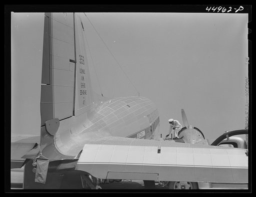Checking the fuel of an airliner. Municipal airport, Washington, D.C.