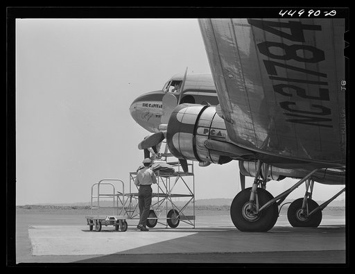 Loading baggage aboard an airliner. Washington D.C. municipal airport