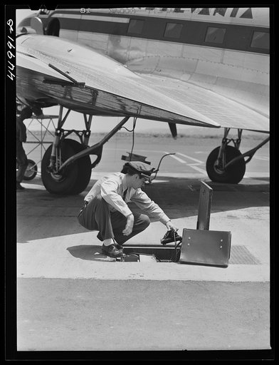 Untitled photo, possibly related to: Using the field phone which connects with the administration building. Washington D.C. municipal airport