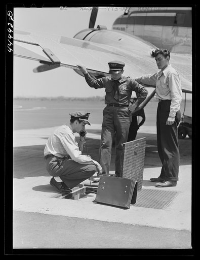 Using the field phone which connects with the administration building. Washington D.C. municipal airport