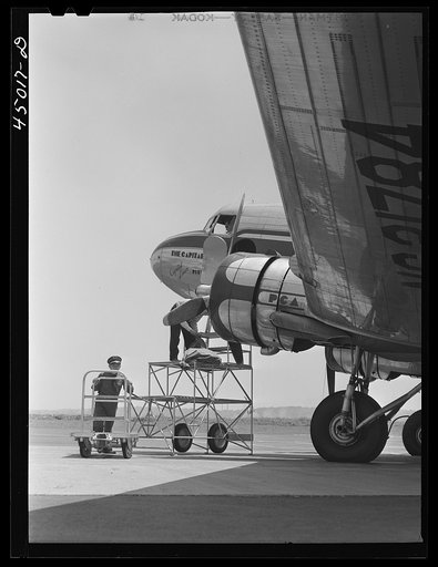 Untitled photo, possibly related to: Loading baggage aboard an airliner. Washington D.C. municipal airport