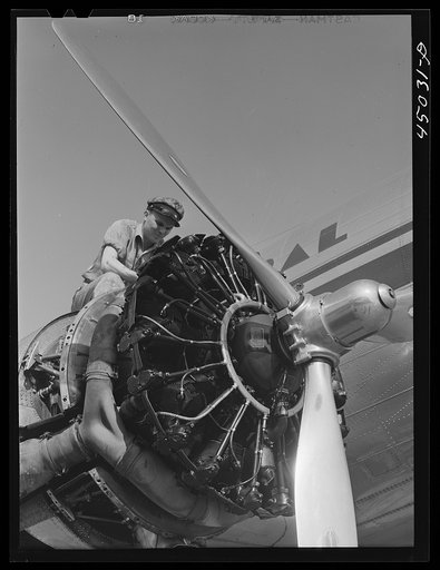 Untitled photo, possibly related to: Working on an engine of one of the airliners. Washington, D.C. municipal airport