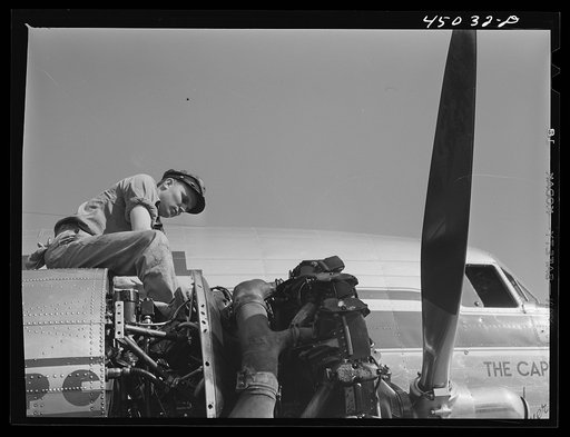 Working on an engine of one of the airliners. Washington, D.C. municipal airport