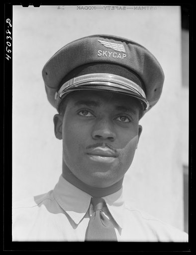 Untitled photo, possibly related to: "Skycaps" at the entrance to the administration building. Municipal airport, Washington, D.C.