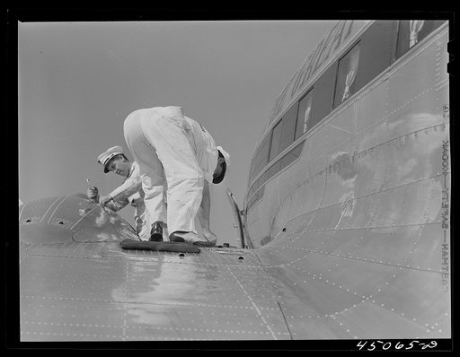 Checking the fuel of an airliner. Municipal airport, Washington, D.C.