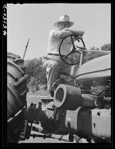 Brattleboro merchant cutting hay with a tractor on his farm on the Bellows Falls road. Vermont