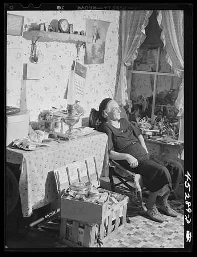 Untitled photo, possibly related to: Mrs. Myrtle Higgins of Leraysville, New York, with some of the belongings she has packed preparing to move out of the area being taken over by the Army. Mrs. Higgins has been selling eggs and berries in the town and her son added to her two dollar a week income b