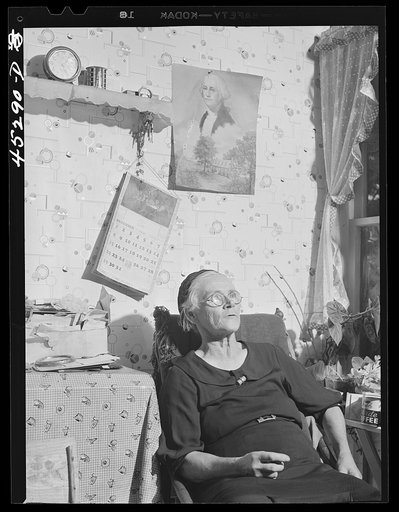 Mrs. Myrtle Higgins of Leraysville, New York, with some of the belongings she has packed preparing to move out of the area being taken over by the Army. Mrs. Higgins has been selling eggs and berries in the town and her son added to her two dollar a week income by working in a junk yard in Watertown