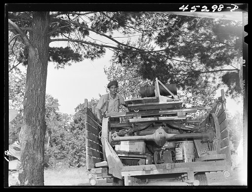 Mr. Fred Longamore helping his brother move out of the Pine Camp expansion area to a new farm fifty-six miles away. Mr. Longamore's own farm is also in the area. Near Pine Camp, New York