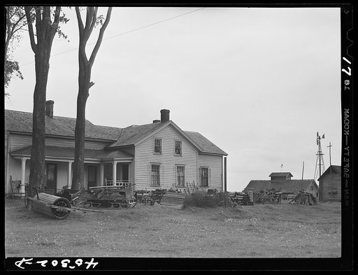 Untitled photo, possibly related to: The O'Connell homestead in the Pine Camp expansion area. The articles outside the house are to be sold at auction in preparation for moving out of the area. Near Pine Camp, New York