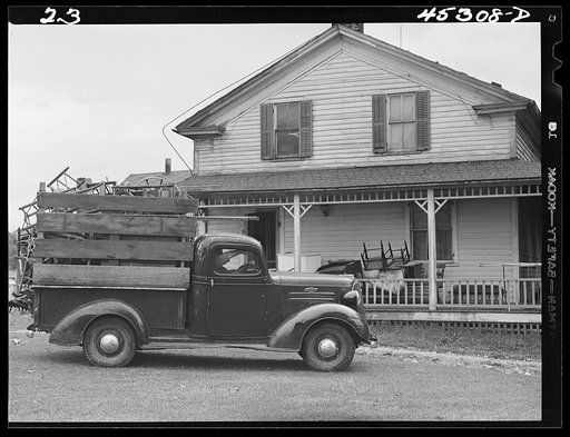 Truck load of household goods at a farm in the Pine Camp expansion area. Most farm families needed several truckloads a day to get their belongings out of the area. Near Pine Camp, New York